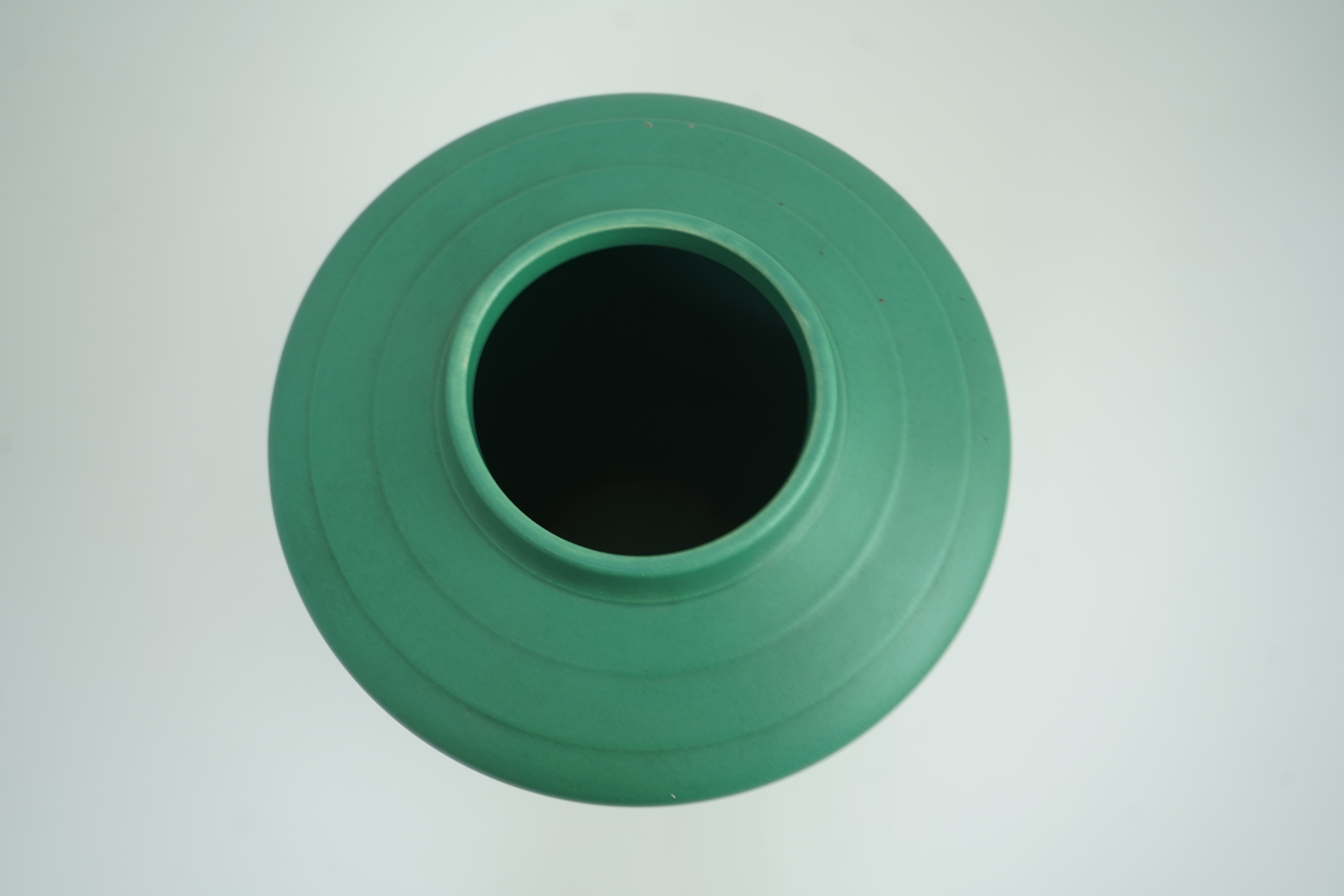 Keith Murray MC RDI FRIBA (New Zealand/British, 1892-1981) for Wedgwood: A matt green glazed tapering vase